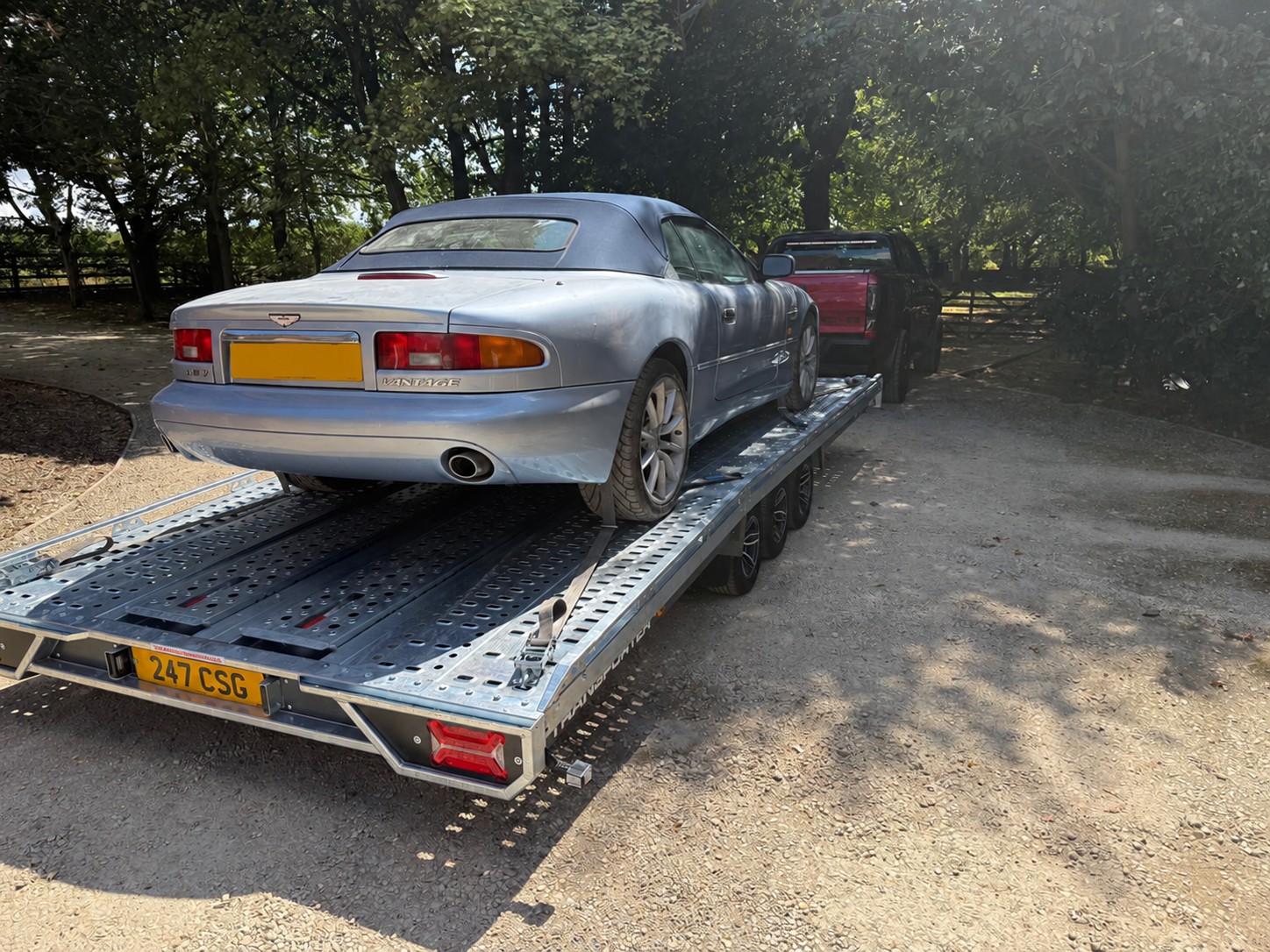 Silver Aston Martin convertible secured on a CSG transport trailer